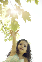 Girl Reaching for a Leaf